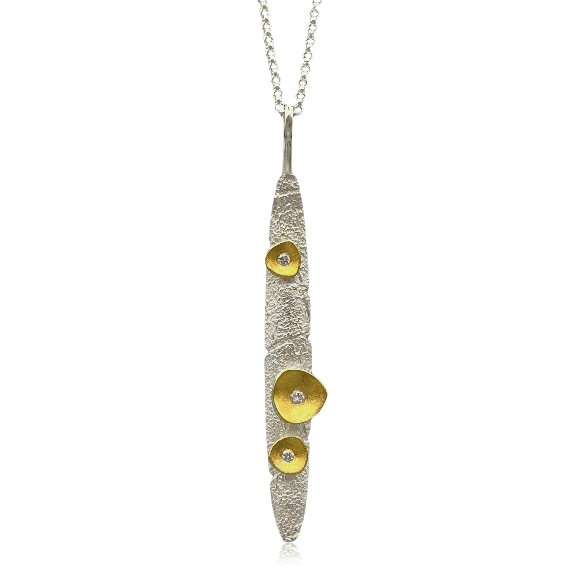 Silver and gold pendant necklace on a white background