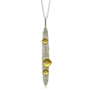 Silver and gold pendant necklace on a white background